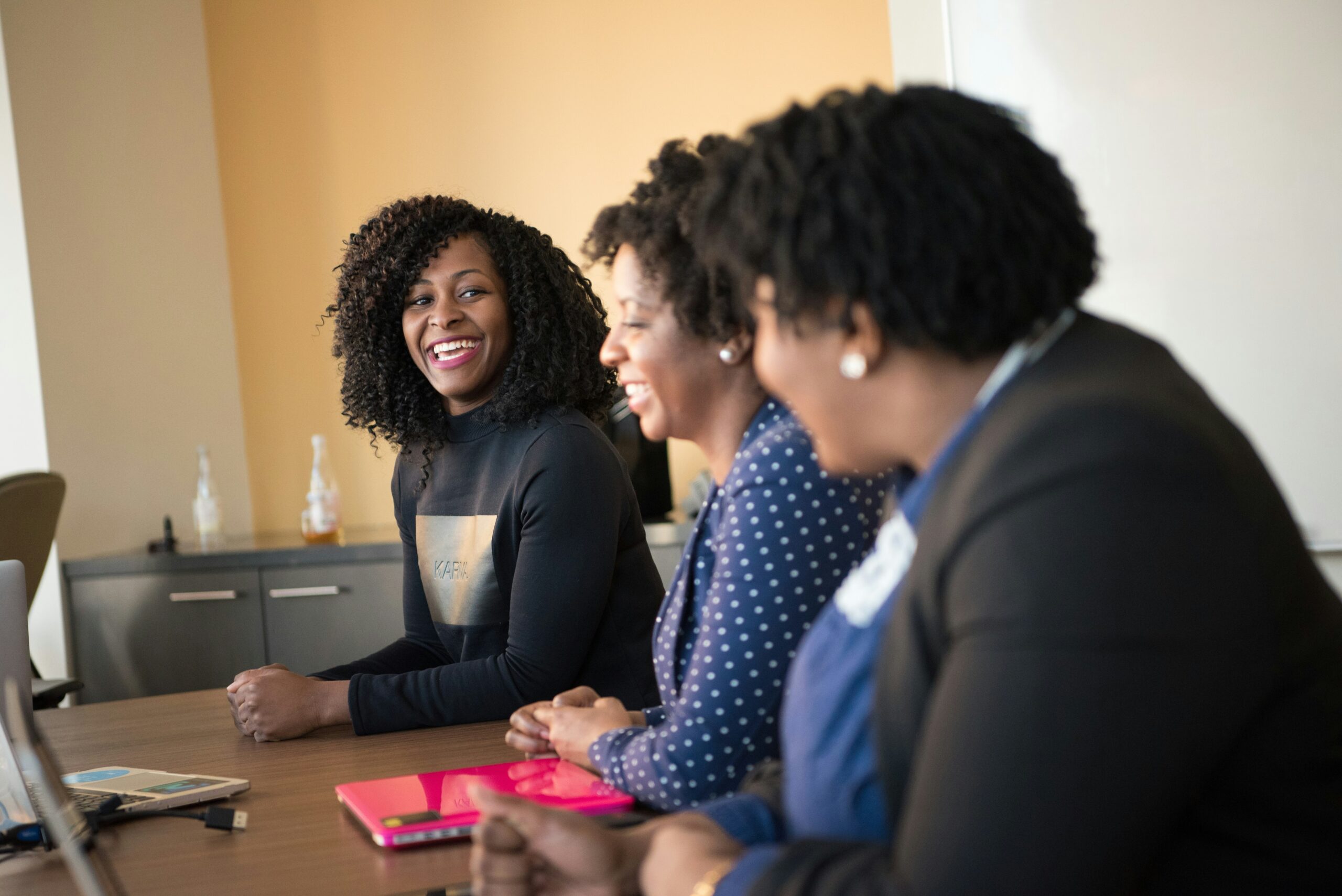 Group of three women at a table in discussion