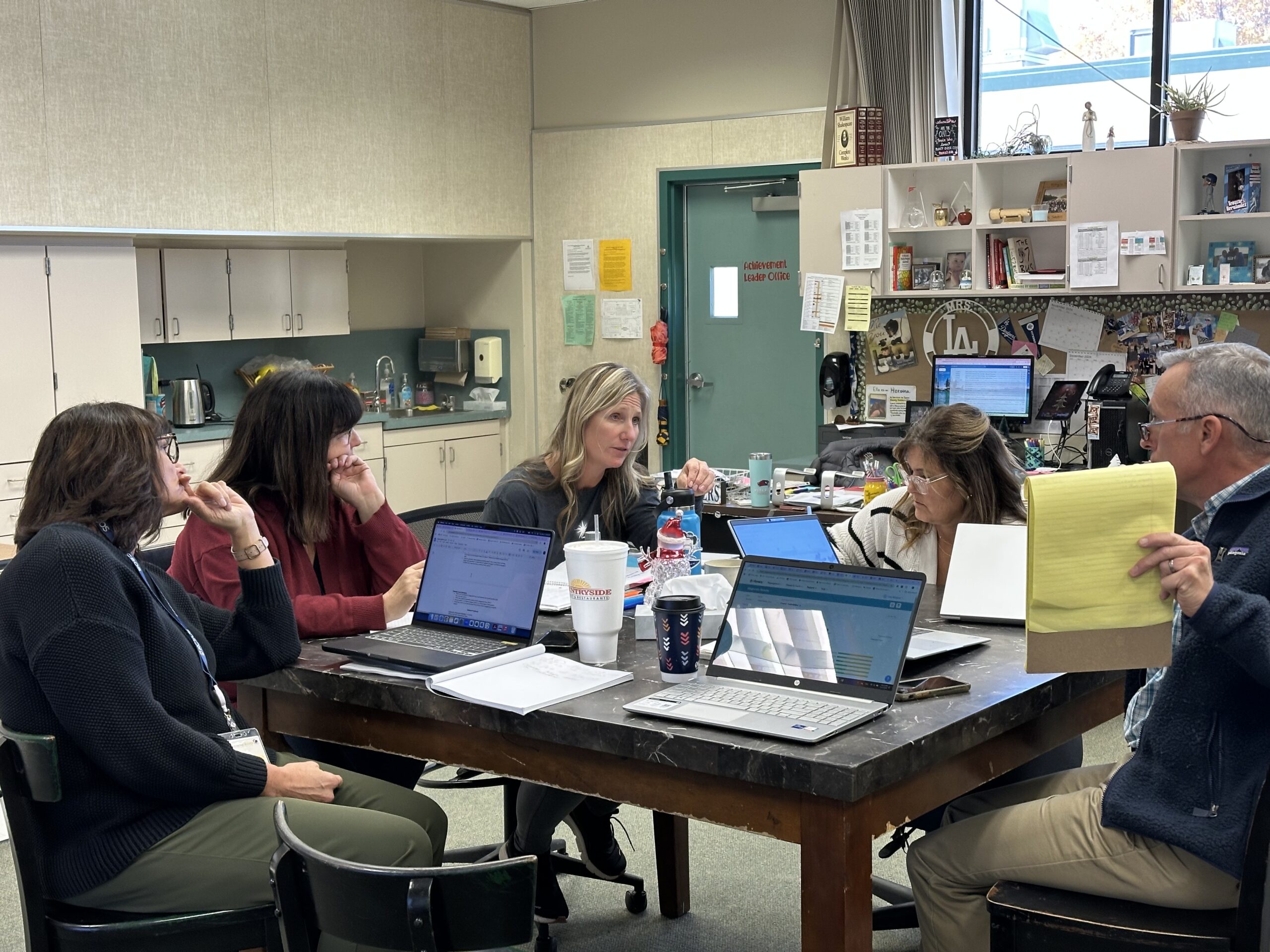 Group o teachers meeting in a teacher lounge